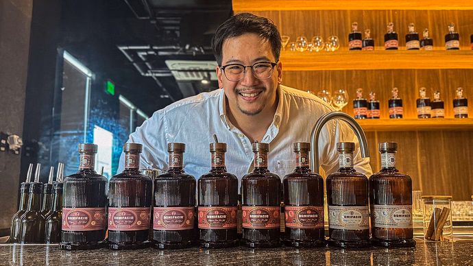 Aaron Aw with Bonifacio rum bottles